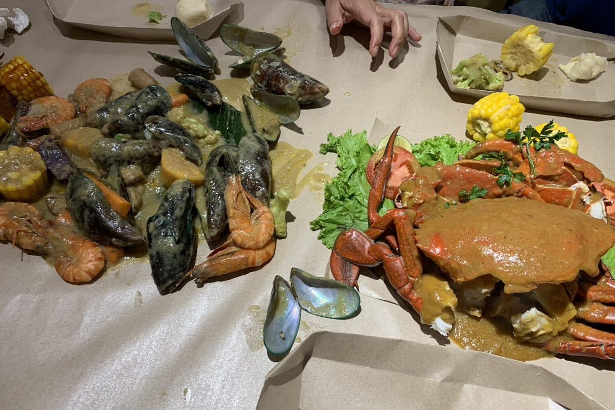 A seafood spread with crab, mussels, and corn